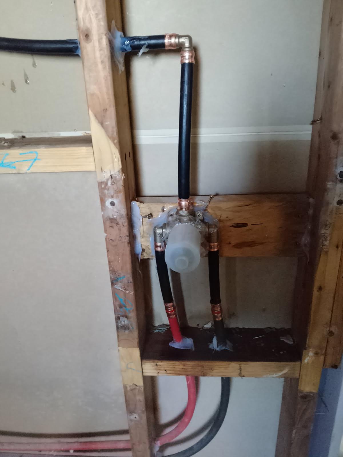 Shower mixer body and lagged pex pipework roughed into a Canberra bathroom wall
